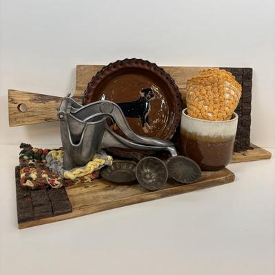 LOT 28: Wooden Charcuterie Boards, Vintage Wear-Ever Citrus Juicer, Crocheted Potholders, A. Loercher Earthenware/ Pottery Pie Plate...