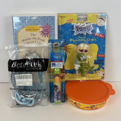 LOT 86: NIP Rug Rats Squeezable Tommy Light, NIP Oral-B Disney's Doc McStuffins Power Toothbrush, Winnie the Pooh Read Out-ALoud...