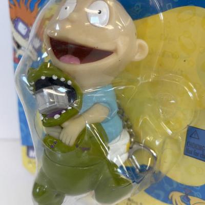 LOT 86: NIP Rug Rats Squeezable Tommy Light, NIP Oral-B Disney's Doc McStuffins Power Toothbrush, Winnie the Pooh Read Out-ALoud...