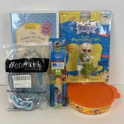 LOT 86: NIP Rug Rats Squeezable Tommy Light, NIP Oral-B Disney's Doc McStuffins Power Toothbrush, Winnie the Pooh Read Out-ALoud...