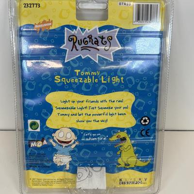 LOT 86: NIP Rug Rats Squeezable Tommy Light, NIP Oral-B Disney's Doc McStuffins Power Toothbrush, Winnie the Pooh Read Out-ALoud...