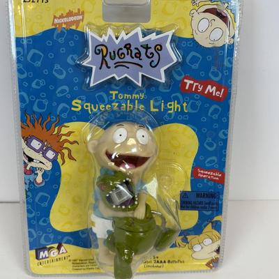 LOT 86: NIP Rug Rats Squeezable Tommy Light, NIP Oral-B Disney's Doc McStuffins Power Toothbrush, Winnie the Pooh Read Out-ALoud...