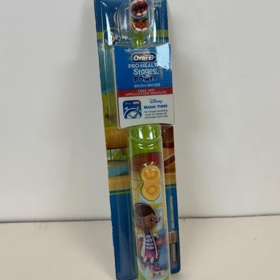 LOT 86: NIP Rug Rats Squeezable Tommy Light, NIP Oral-B Disney's Doc McStuffins Power Toothbrush, Winnie the Pooh Read Out-ALoud...