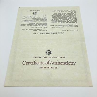 LOT 103: United States Mint 1988 Prestige Set with 1988 U.S. Olympic Silver Dollar in Presentation Book with Certificate of Authenticity