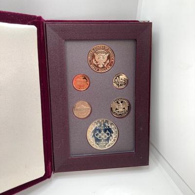 LOT 103: United States Mint 1988 Prestige Set with 1988 U.S. Olympic Silver Dollar in Presentation Book with Certificate of Authenticity