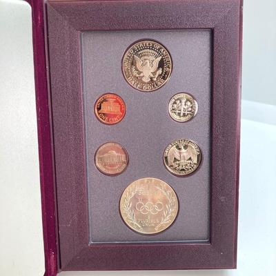 LOT 103: United States Mint 1988 Prestige Set with 1988 U.S. Olympic Silver Dollar in Presentation Book with Certificate of Authenticity