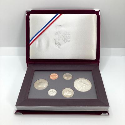 LOT 103: United States Mint 1988 Prestige Set with 1988 U.S. Olympic Silver Dollar in Presentation Book with Certificate of Authenticity
