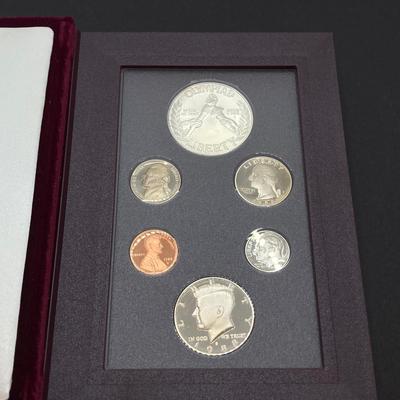 LOT 103: United States Mint 1988 Prestige Set with 1988 U.S. Olympic Silver Dollar in Presentation Book with Certificate of Authenticity