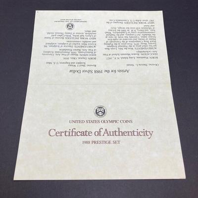 LOT 103: United States Mint 1988 Prestige Set with 1988 U.S. Olympic Silver Dollar in Presentation Book with Certificate of Authenticity