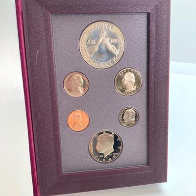 LOT 103: United States Mint 1988 Prestige Set with 1988 U.S. Olympic Silver Dollar in Presentation Book with Certificate of Authenticity