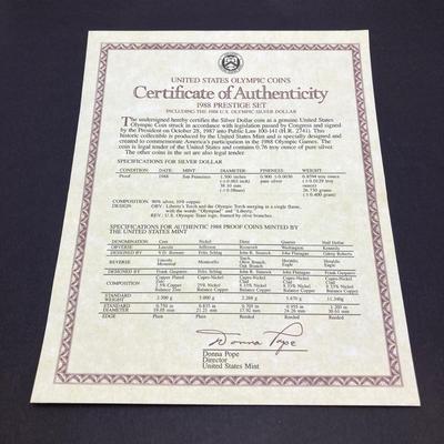 LOT 103: United States Mint 1988 Prestige Set with 1988 U.S. Olympic Silver Dollar in Presentation Book with Certificate of Authenticity