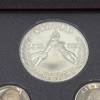 LOT 103: United States Mint 1988 Prestige Set with 1988 U.S. Olympic Silver Dollar in Presentation Book with Certificate of Authenticity
