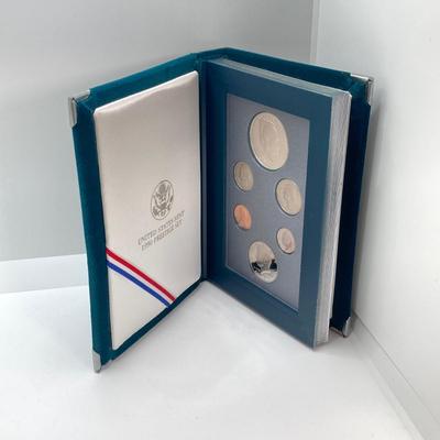 LOT 104: United States Mint 1990 Prestige Set with 1990 Eisenhower Centennial Silver Dollar in Presentation Book with Certificate of...