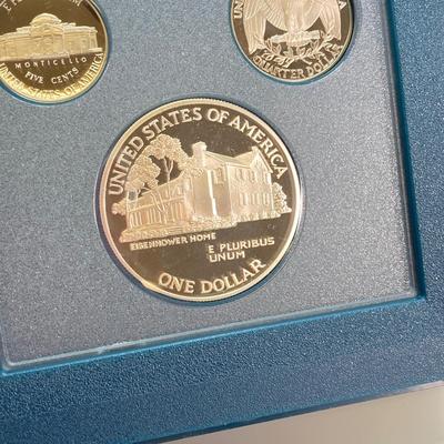 LOT 104: United States Mint 1990 Prestige Set with 1990 Eisenhower Centennial Silver Dollar in Presentation Book with Certificate of...