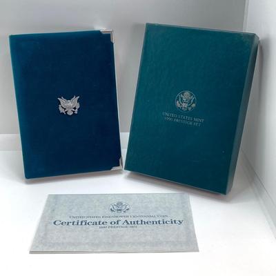 LOT 104: United States Mint 1990 Prestige Set with 1990 Eisenhower Centennial Silver Dollar in Presentation Book with Certificate of...