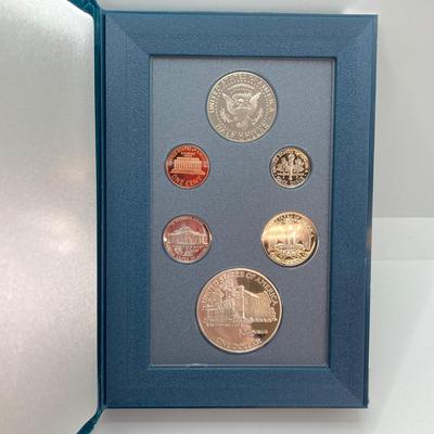 LOT 104: United States Mint 1990 Prestige Set with 1990 Eisenhower Centennial Silver Dollar in Presentation Book with Certificate of...