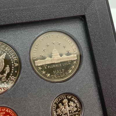 LOT 105: United States Mint 1989 Prestige Set with 1989 Congressional Silver Dollar and Half Dollar in Presentation Book with Certificate...
