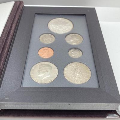 LOT 105: United States Mint 1989 Prestige Set with 1989 Congressional Silver Dollar and Half Dollar in Presentation Book with Certificate...