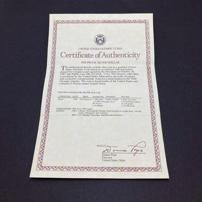 LOT 106: United States Mint 1988 Olympic Silver Dollar Proof Coin with Presentation Box and Certificate of Authenticity