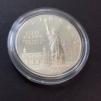 LOT 110: Pair of 1986 United States Liberty Coin Sets with Silver Dollar Coins in Presentation Boxes with Certificate of Authenticity