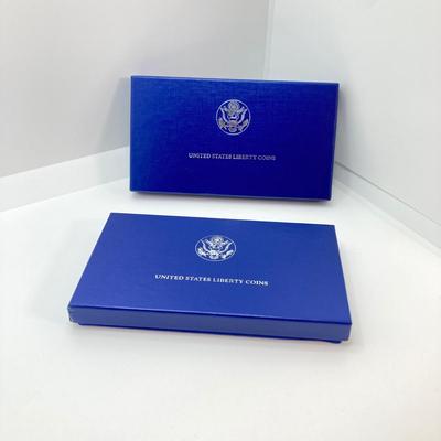 LOT 110: Pair of 1986 United States Liberty Coin Sets with Silver Dollar Coins in Presentation Boxes with Certificate of Authenticity