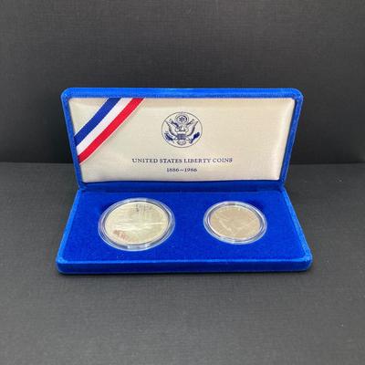LOT 110: Pair of 1986 United States Liberty Coin Sets with Silver Dollar Coins in Presentation Boxes with Certificate of Authenticity