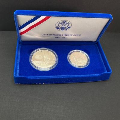 LOT 110: Pair of 1986 United States Liberty Coin Sets with Silver Dollar Coins in Presentation Boxes with Certificate of Authenticity