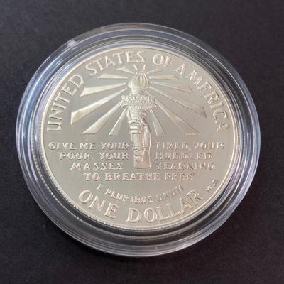 LOT 110: Pair of 1986 United States Liberty Coin Sets with Silver Dollar Coins in Presentation Boxes with Certificate of Authenticity