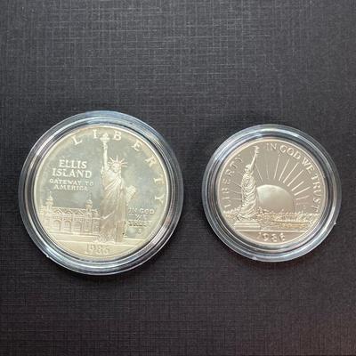 LOT 110: Pair of 1986 United States Liberty Coin Sets with Silver Dollar Coins in Presentation Boxes with Certificate of Authenticity