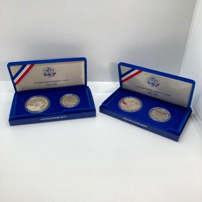 LOT 110: Pair of 1986 United States Liberty Coin Sets with Silver Dollar Coins in Presentation Boxes with Certificate of Authenticity
