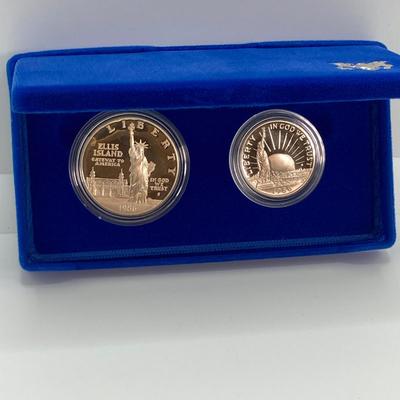 LOT 110: Pair of 1986 United States Liberty Coin Sets with Silver Dollar Coins in Presentation Boxes with Certificate of Authenticity