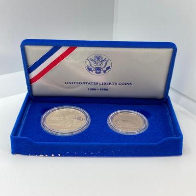 LOT 110: Pair of 1986 United States Liberty Coin Sets with Silver Dollar Coins in Presentation Boxes with Certificate of Authenticity