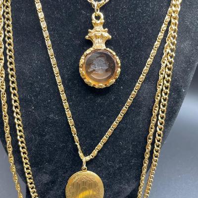 2 interesting gold tone necklaces