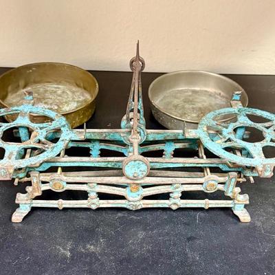 Sale Photo Thumbnail #650: This is a vintage cast iron balance scale with brass pans.