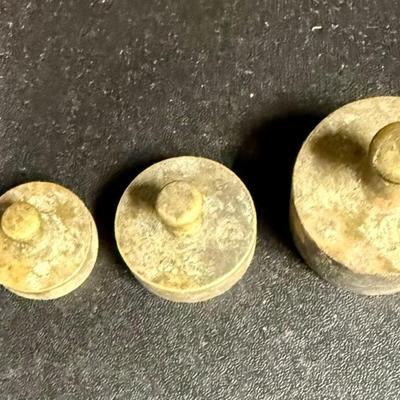 Sale Photo Thumbnail #669: Antique set of brass scale weights in a wooden box. 7 weights are included, the smallest one is missing.  Box hinge is broken.
