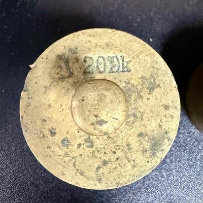 Sale Photo Thumbnail #667: Antique set of brass scale weights in a wooden box. 7 weights are included, the smallest one is missing.  Box hinge is broken.