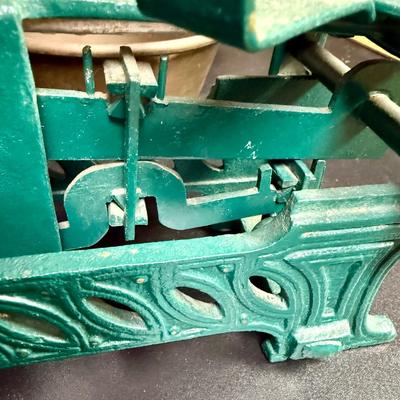 Sale Photo Thumbnail #675: This is a vintage or antique French cast iron balance scale, also known as a force or market scale, with brass pans.
