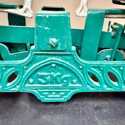 Sale Photo Thumbnail #672: This is a vintage or antique French cast iron balance scale, also known as a force or market scale, with brass pans.