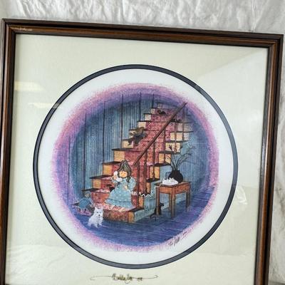 Sale Photo Thumbnail #355: 1988 The item is a framed limited edition print titled "I Love You Grandma" by artist P. Buckley Moss. 
It is a limited edition piece, often hand-signed and numbered by the artist. 
The image depicts a young girl on a staircase with cats. 20 X 20"