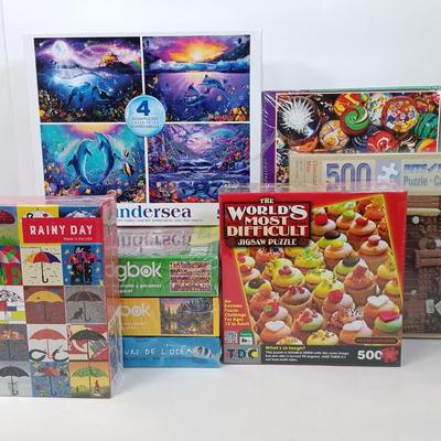 LOT 156: NIP Set of (8) 500 and 1000 Pc Puzzles