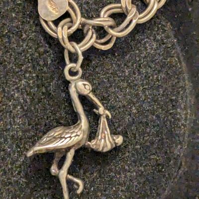 double link sterling silver charm bracelet with stork and other charm- weights 18 grams