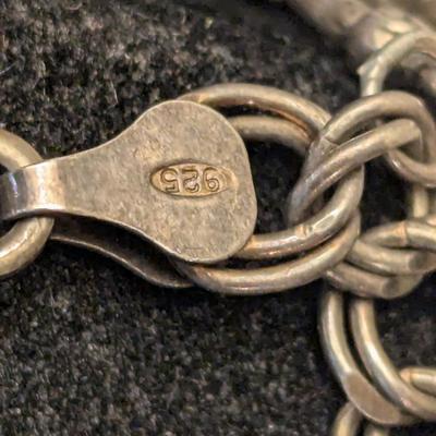 double link sterling silver charm bracelet with stork and other charm- weights 18 grams