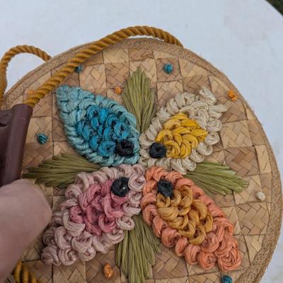 vintage raffia and straw bucket-style basket purse with a floral motif and rope handles