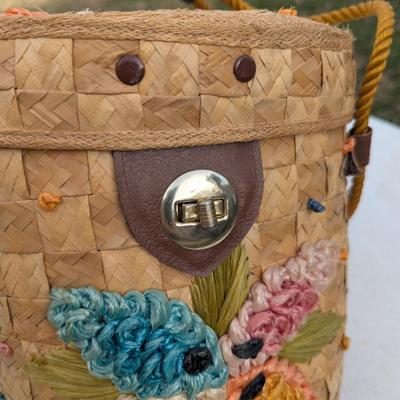 vintage raffia and straw bucket-style basket purse with a floral motif and rope handles