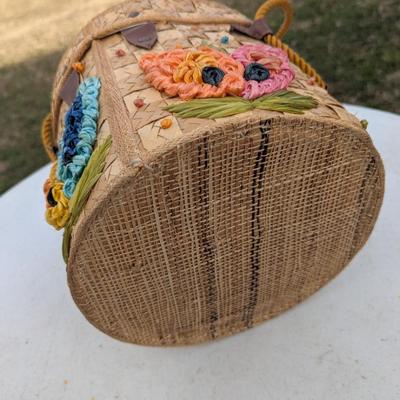 vintage raffia and straw bucket-style basket purse with a floral motif and rope handles