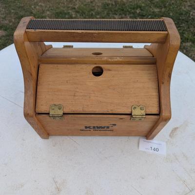 vintage shoe shine kit, which includes a wooden storage box, brushes, cloths, and several tins of shoe polish