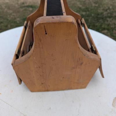 vintage shoe shine kit, which includes a wooden storage box, brushes, cloths, and several tins of shoe polish