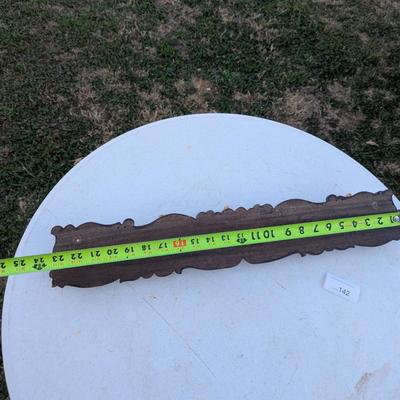  wall-mounted coat and hat rack with six brass-toned hooks.