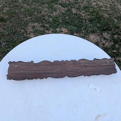  wall-mounted coat and hat rack with six brass-toned hooks.