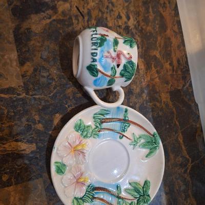 vintage Florida souvenir ceramic demitasse cup and saucer set featuring a pink flamingo and palm trees.